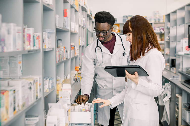 Pharmacists looking up a medicine for a patient