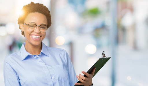 smiling woman holding a document