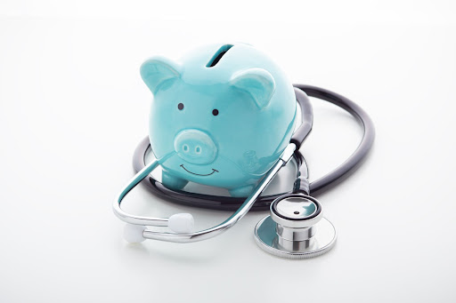 piggy bank and stethoscope