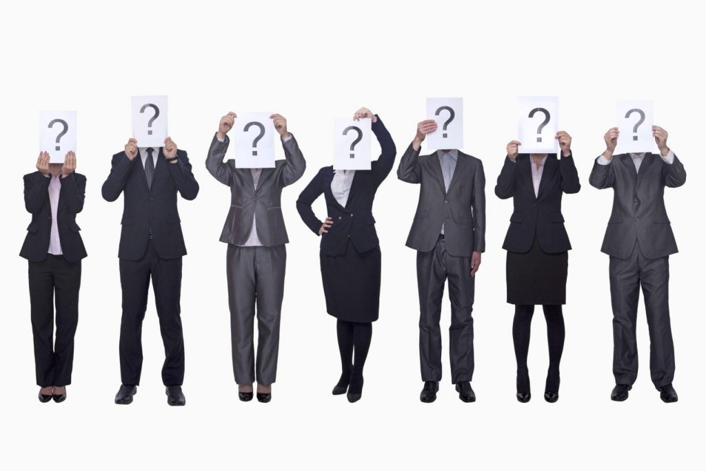 group holding questionmark signs