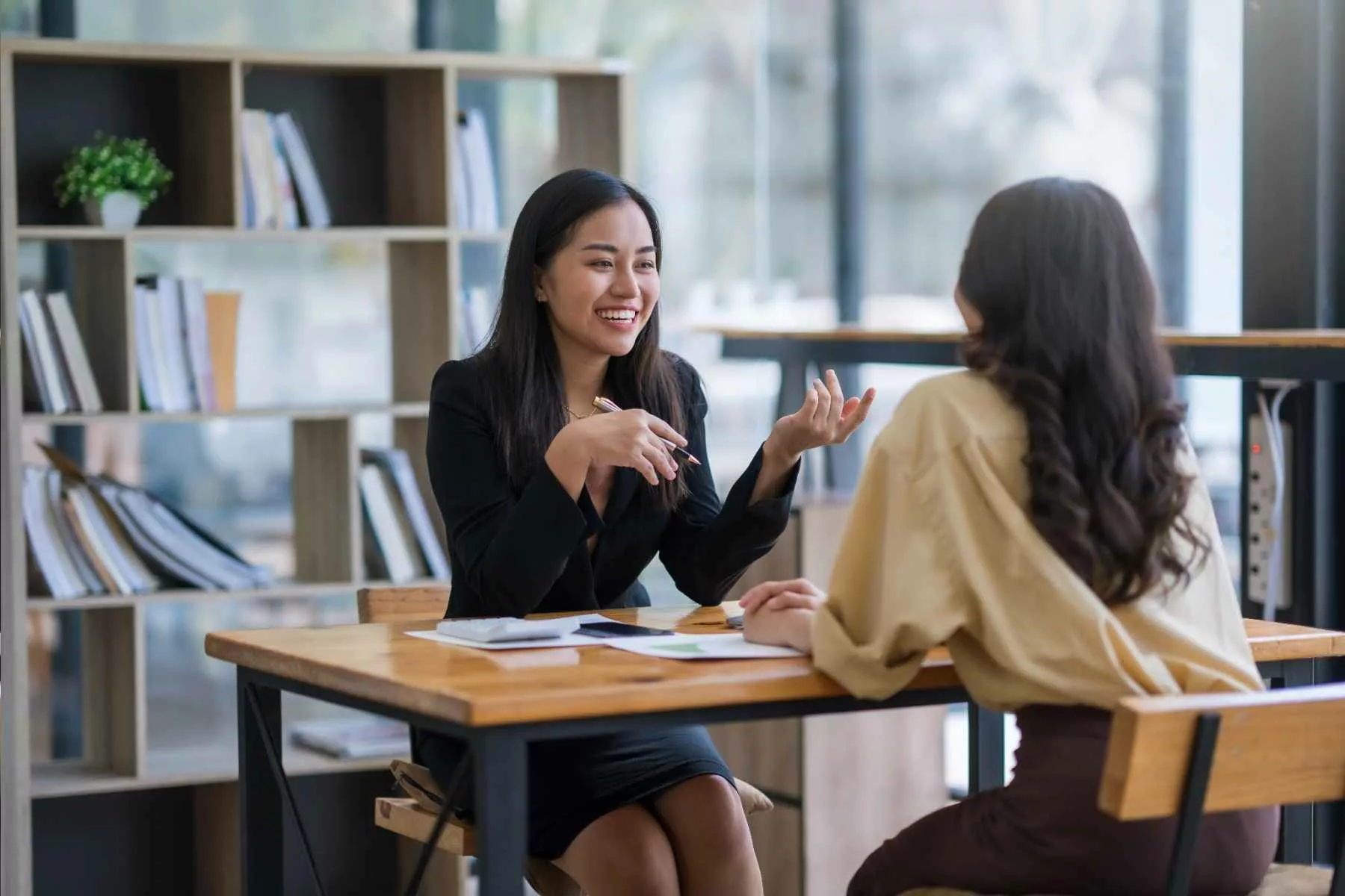 two-women-discussing-health-care-cost-containment-in-their-companys-self-funded-insurance-plan_Roundstone Insurance