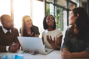 employees-discussing-the-value-of-culturally-competent-healthcare-as-part-of-DEI-initiatives_Roundstone Insurance