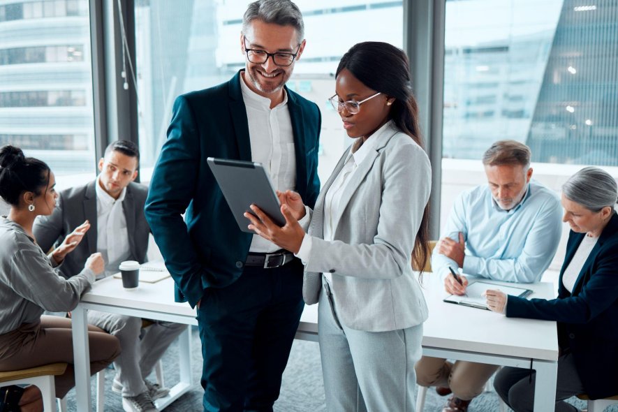 colleagues discussing employer-sponsored health insurance benefits in a modern office setting