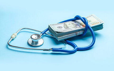 Stethoscope around money for captive insurance plans Image