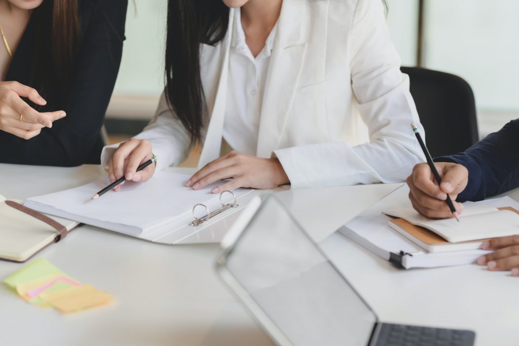 benefit advisors looking at their notes together at a table