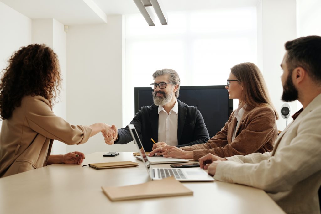 Woman interviewing in front of three people for a new healthcare job