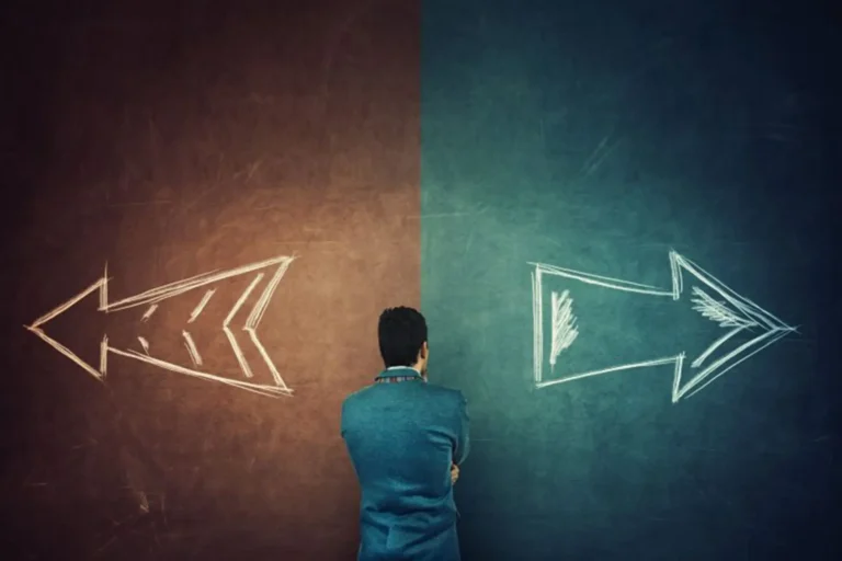 A man facing two chalk arrows pointing in opposite directions, representing a decision.