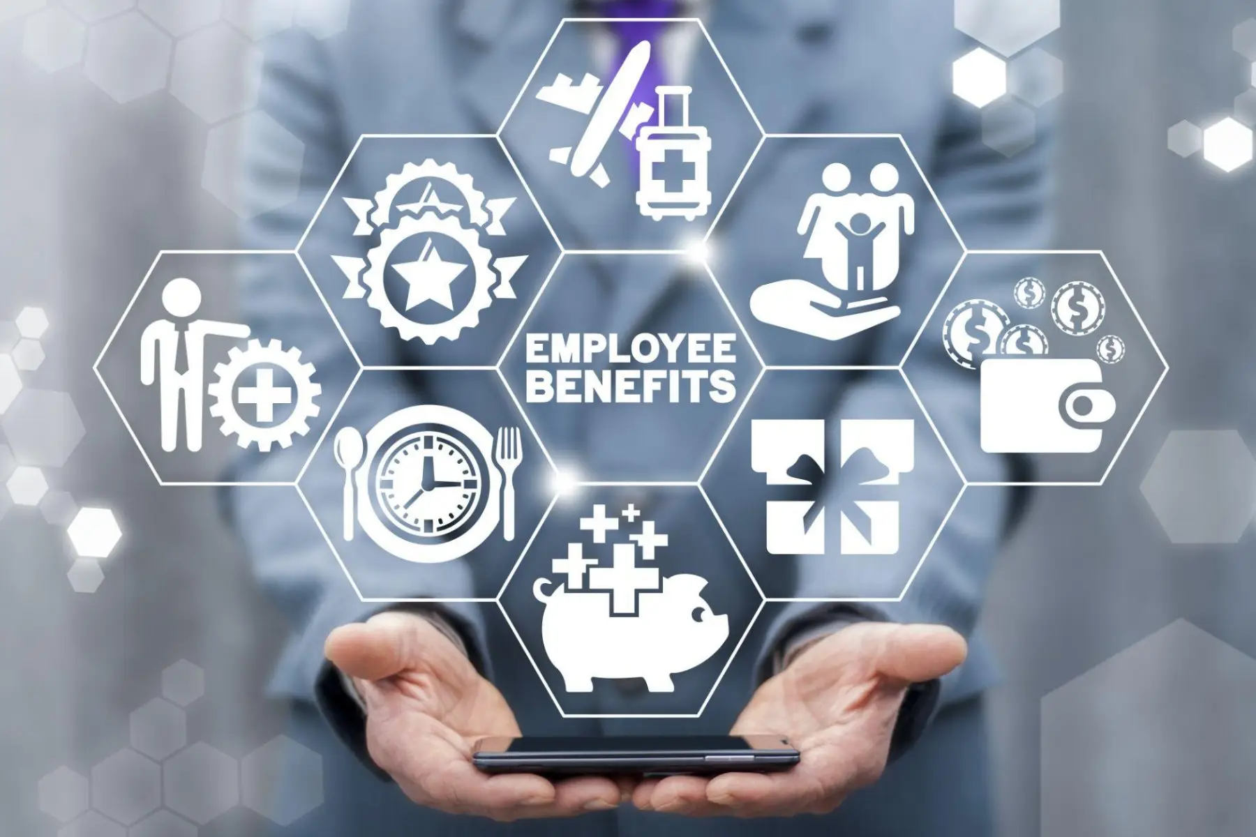 A hand presenting a digital display of employee benefits icons.