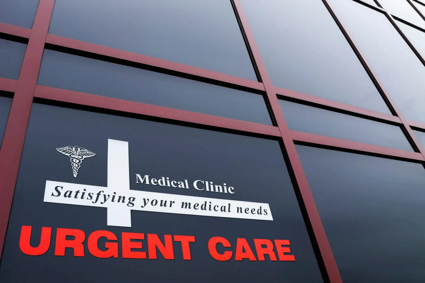 The exterior window signage of an urgent care medical clinic.