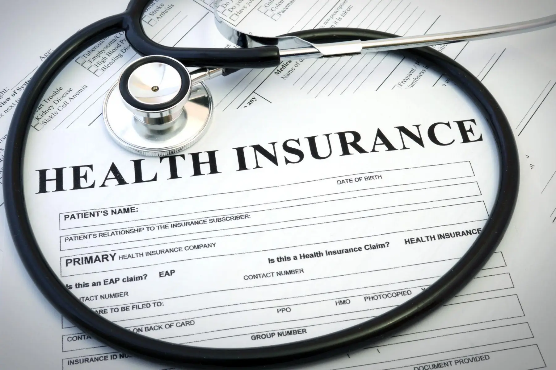 A health insurance claim form with a stethoscope resting on it.