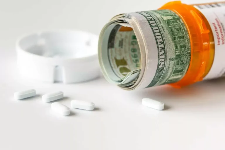 An open prescription bottle with rolled cash inside and white pills spilled beside it, representing pharmacy costs.