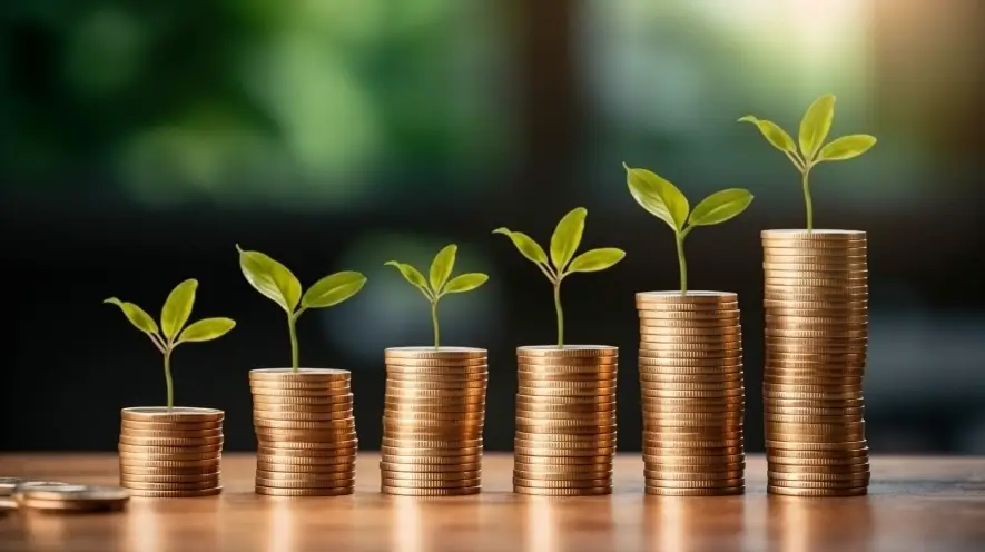 Stacks of coins with plants, symbolizing growth in employer health benefits