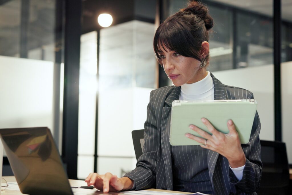 Businesswoman reviewing health plan underwriting documents on tablet