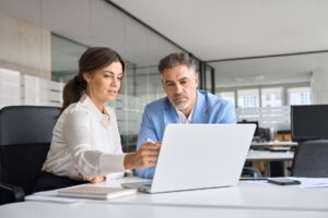 Business partners reviewing TPA options together on a laptop